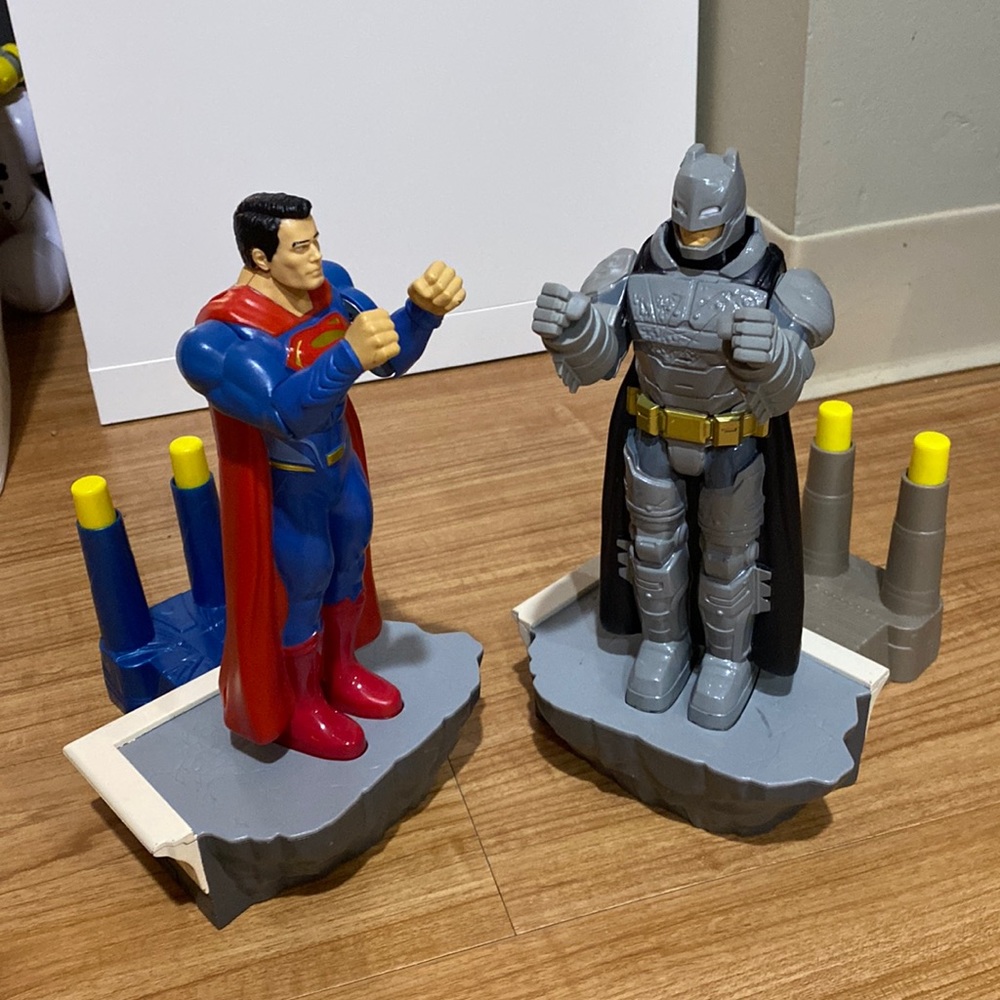 Batman and Superman punching action figures